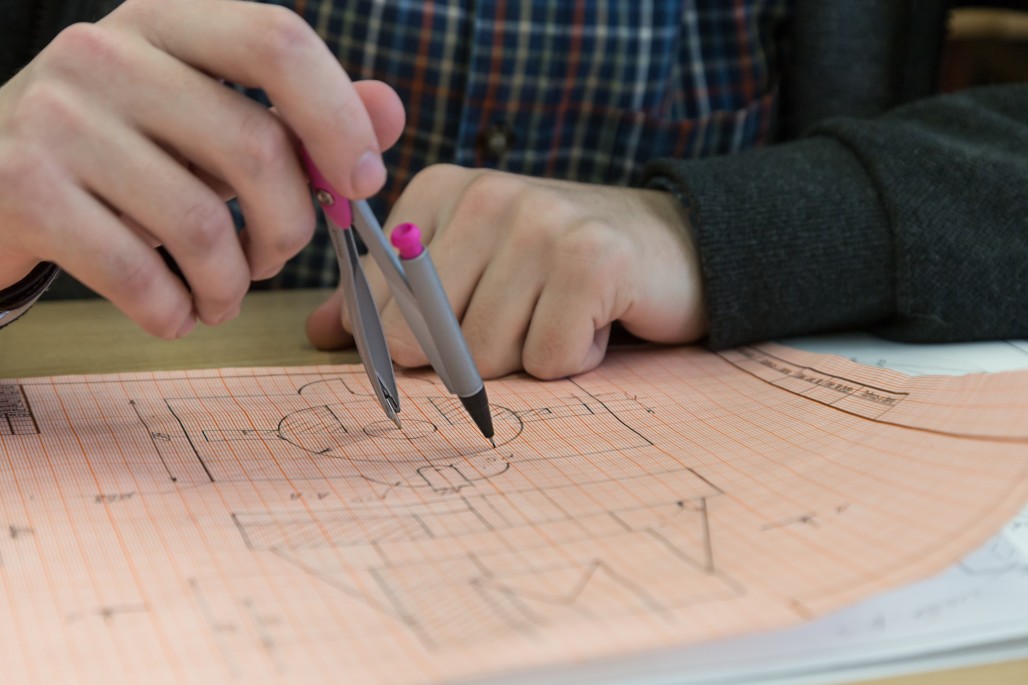 student uses compass to draw on graph paper for accommodations